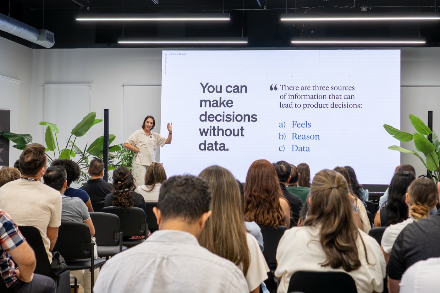 Cassie McDaniel on the main stage beside a slide reading You can make decisions without data